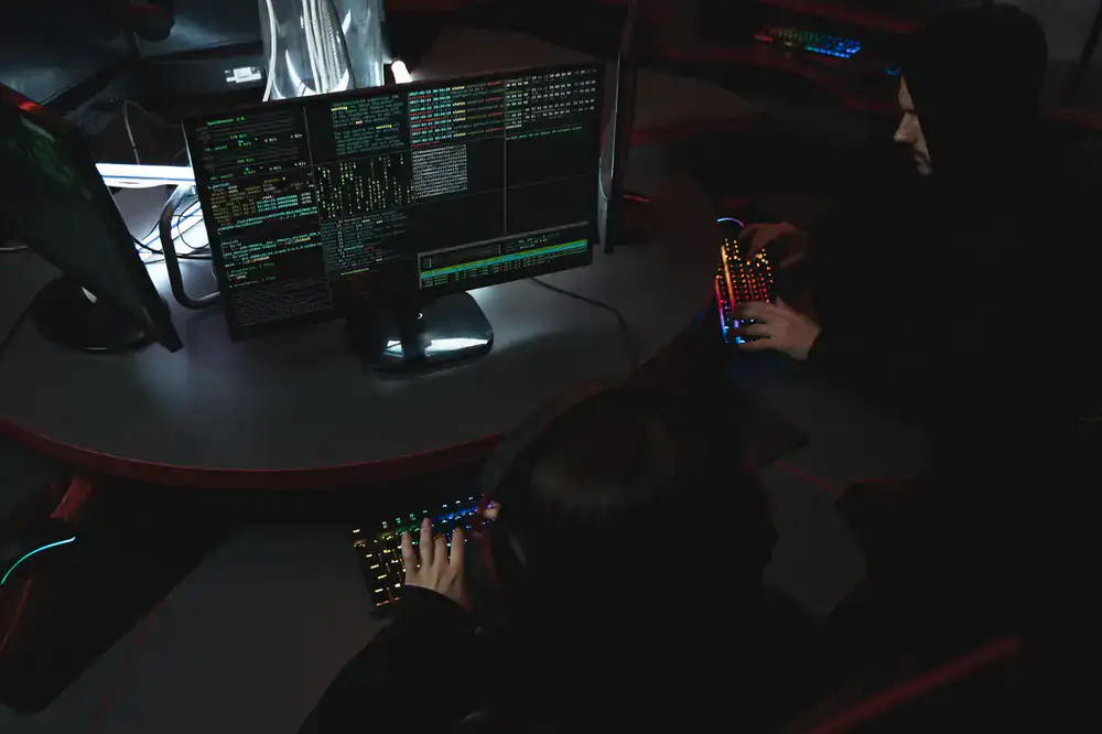 Game developers collaborating intensively during a hackathon event